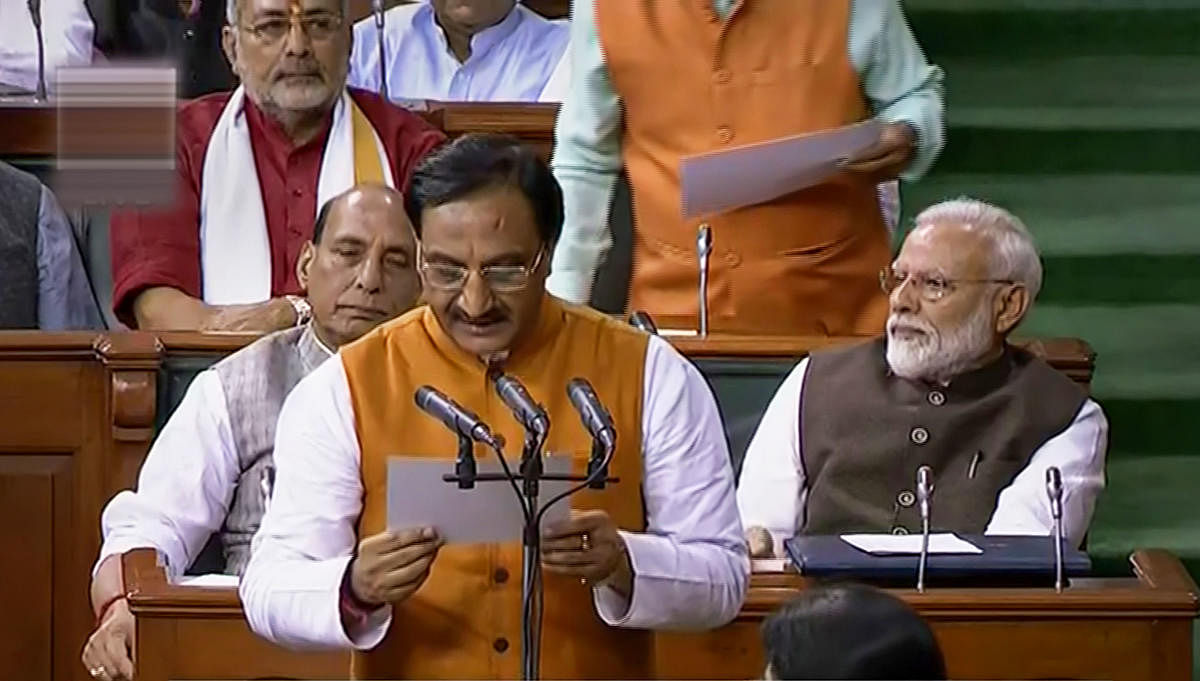 Union Minister for Human Resource Development Ramesh Pokhriyal ‘Nishank' takes oath as a member of the 17th Lok Sabha, at Parliament House in New Delhi. (PTI Photo)