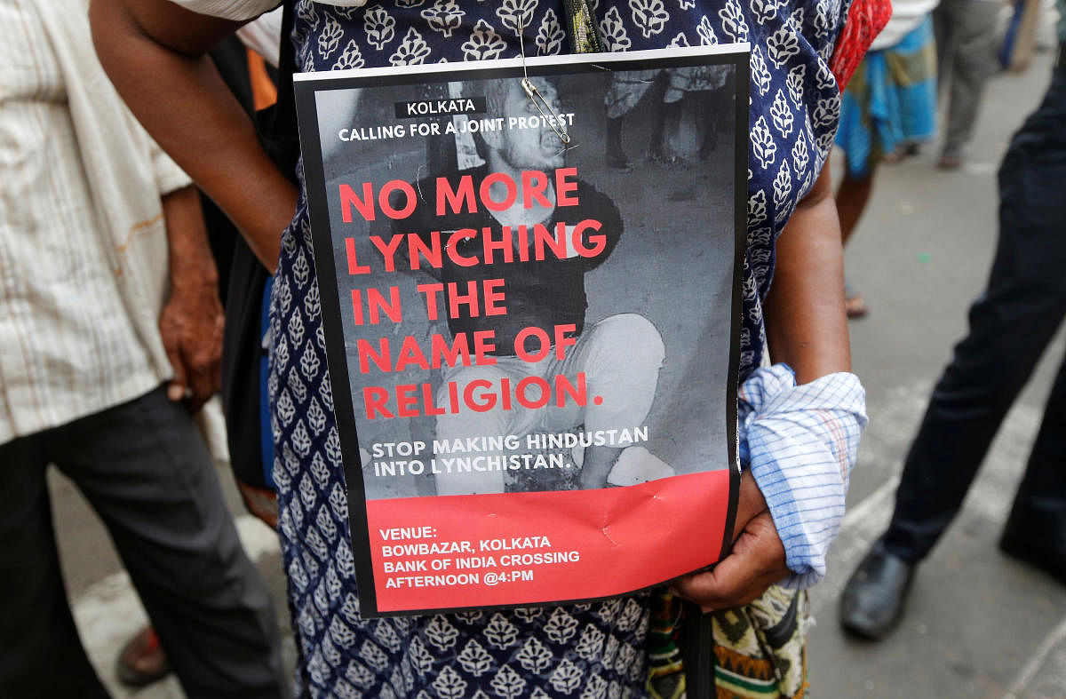 A woman holds a placard during a protest against the lynching of Tabrez Ansari by a mob, in Kolkata on June 26, 2019. REUTERS