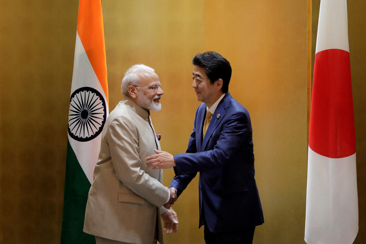 Narendra Modi, India's prime minister, shakes hands with Shinzo Abe, Japan's prime minister, during a bilateral meeting ahead of the Group of 20 (G-20) summit in Osaka, Japan, June 27, 2019. Kiyoshi Ota/Pool via Reuters