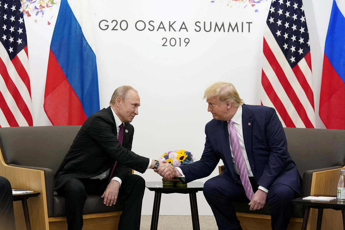 Russia's President Vladimir Putin and U.S. President Donald Trump shake hands during a bilateral meeting at the G20 leaders summit in Osaka, Japan. Reuters