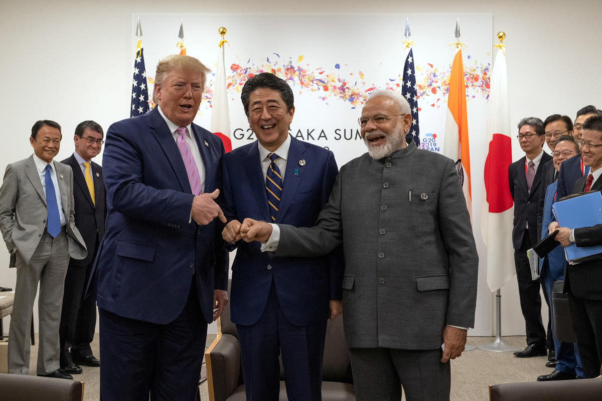 U.S President Donald Trump jokes to the media about fist bumping with Japan's Prime Minister Shinzo Abe and India's Prime Minister Narendra Modi during a trilateral meeting on the first day of the G20 summit on June 28, 2019 in Osaka, Japan. Carl Court/Po