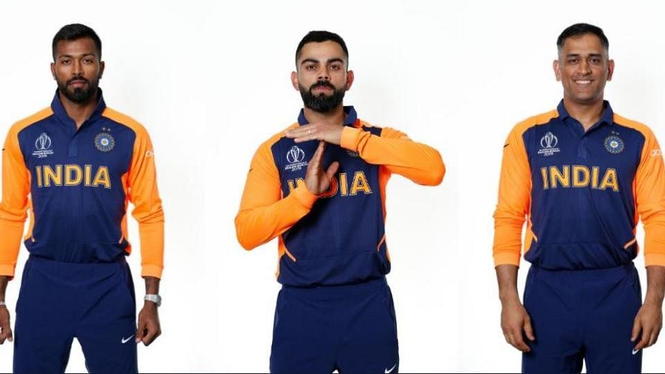 Hardik Pandya, Virat Kohli and MS Dhoni wearing India’s new orange away jersey for their World Cup match against England(Twitter)