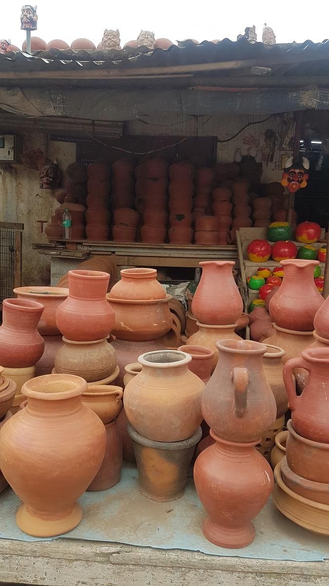 Of all shapes and sizes  Earthenware on display, a diya being made on an electric wheel. Potters residing in Pottery Town in Bengaluru make different kinds of kichenware, garden pots, idols and earthen lamps. Using an electric wheel, a potter can make up