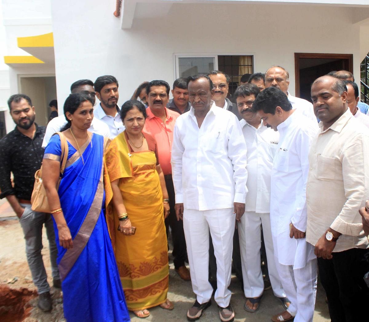 Housing Minister M T B Nagaraj inspects the houses constructed for calamity victims at Jambooru in Somwarpet.