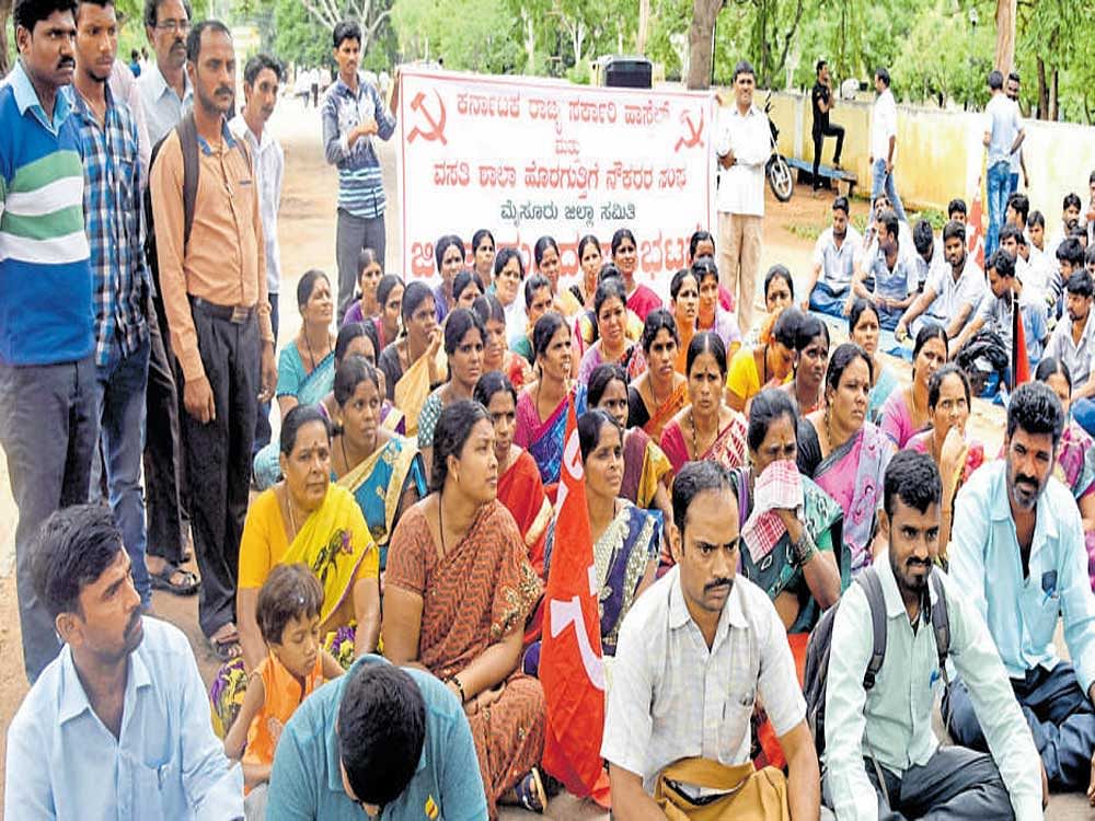 Members of the Karnataka State Government Hostel and Residential Schools Contract Workers' Association stage a protest near the deputy commissioner's office in Mysuru on Saturday. DH photo