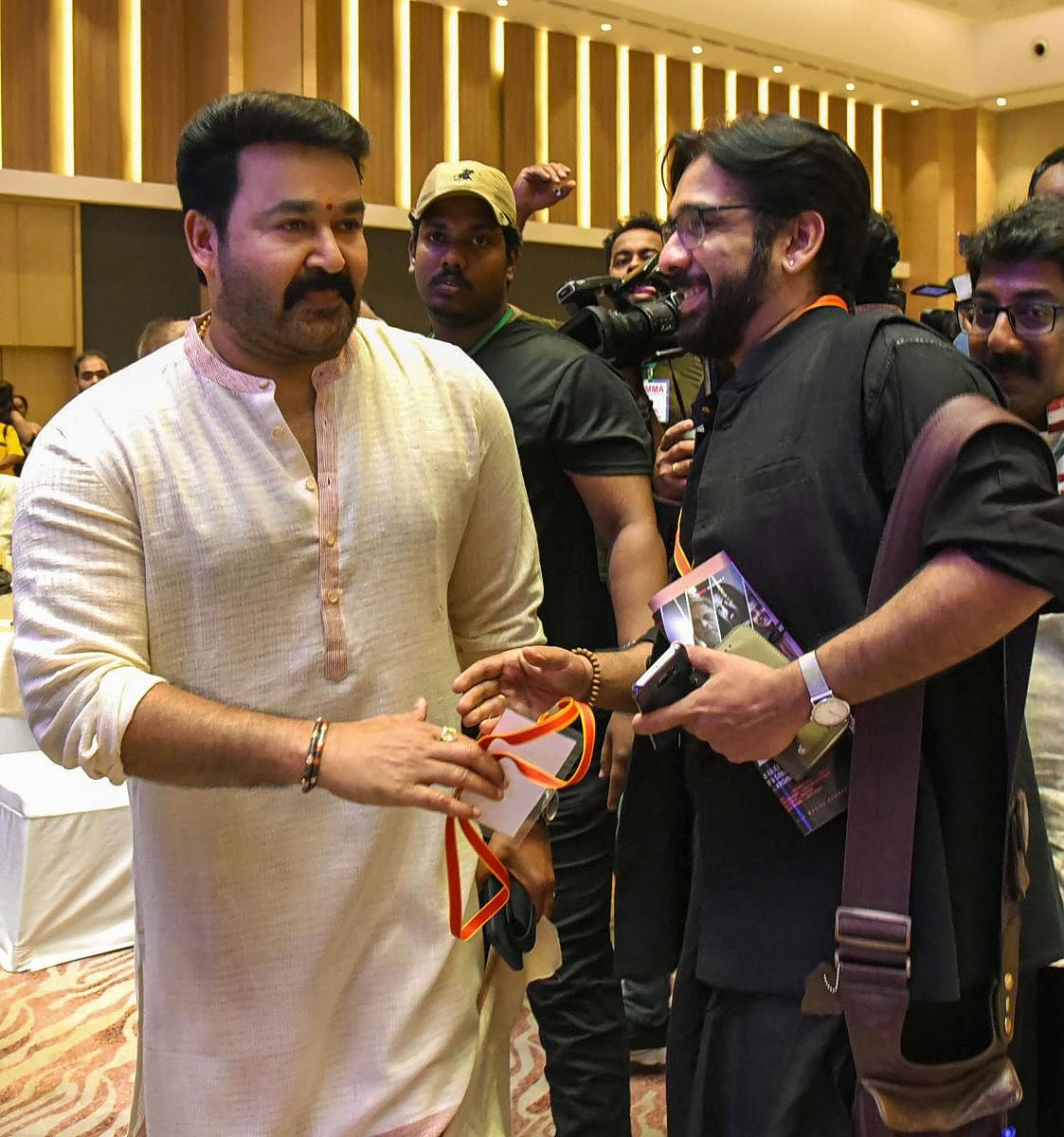 Association of Malayalam Movie Artistes (AMMA) President Mohanlal with actor Vineeth during the AMMA 25th Annual General body meeting, in Kochi, Sunday, June 30, 2019. (PTI Photo)