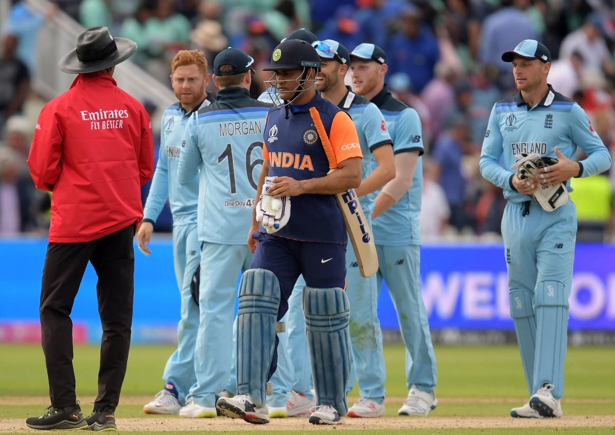 Mahendra Singh Dhoni walks off the field after the defeat in the group stage match against England at Edgbaston. Credit: Dibyangshu Sarkar/AFP