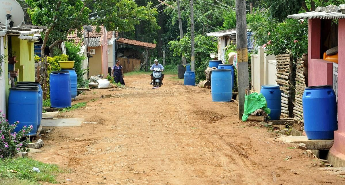 Drums are placed in front of the houses at Kalludoddi Layout in Chikkamagaluru to collect water from water tankers.