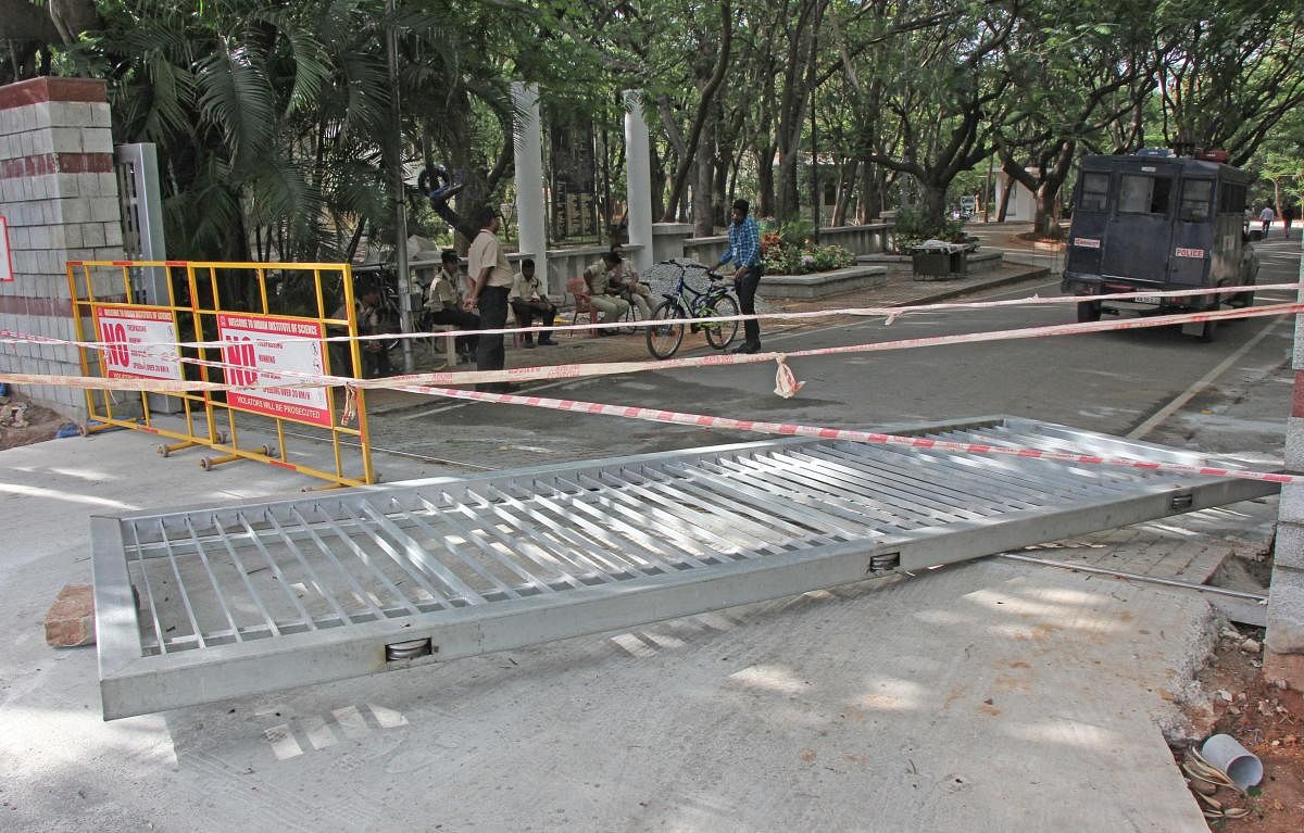 The iron gate that crushed security guard Gowtham Biswas (inset) at the Indian Institute of Science on Sunday. 
