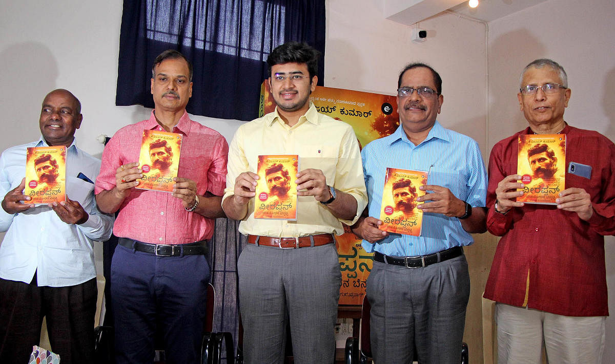 Bengaluru Police Commissioner Alok Kumar, Bangalore South MP L S Tejasvi Surya, retired ADGP Gopal B Hosur and retired DGP D V Guruprasad at the launch of a Kannada book on Veerappan on Sunday. DH PHOTO