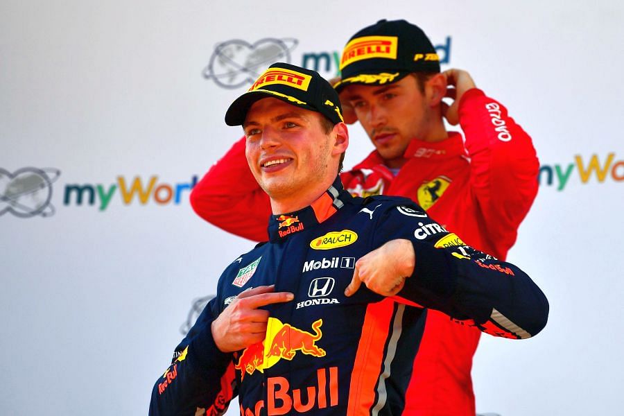 Charles Leclerc (in background) is a dejected man as Max Verstappen celebrates his Austrian GP win. Picture credit: AFP