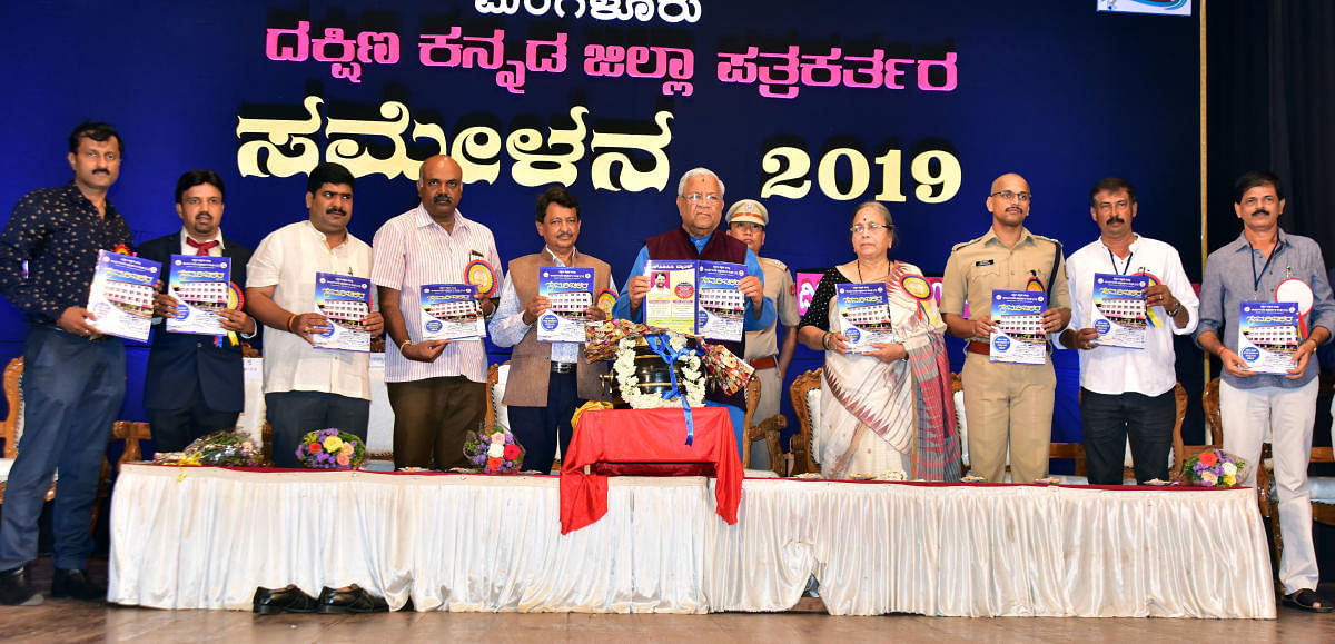 Governor of Nagaland and Governor In-charge of Manipur P B Acharya releases a souvenir at the District Journalists’ Meet in Mangaluru on Monday.