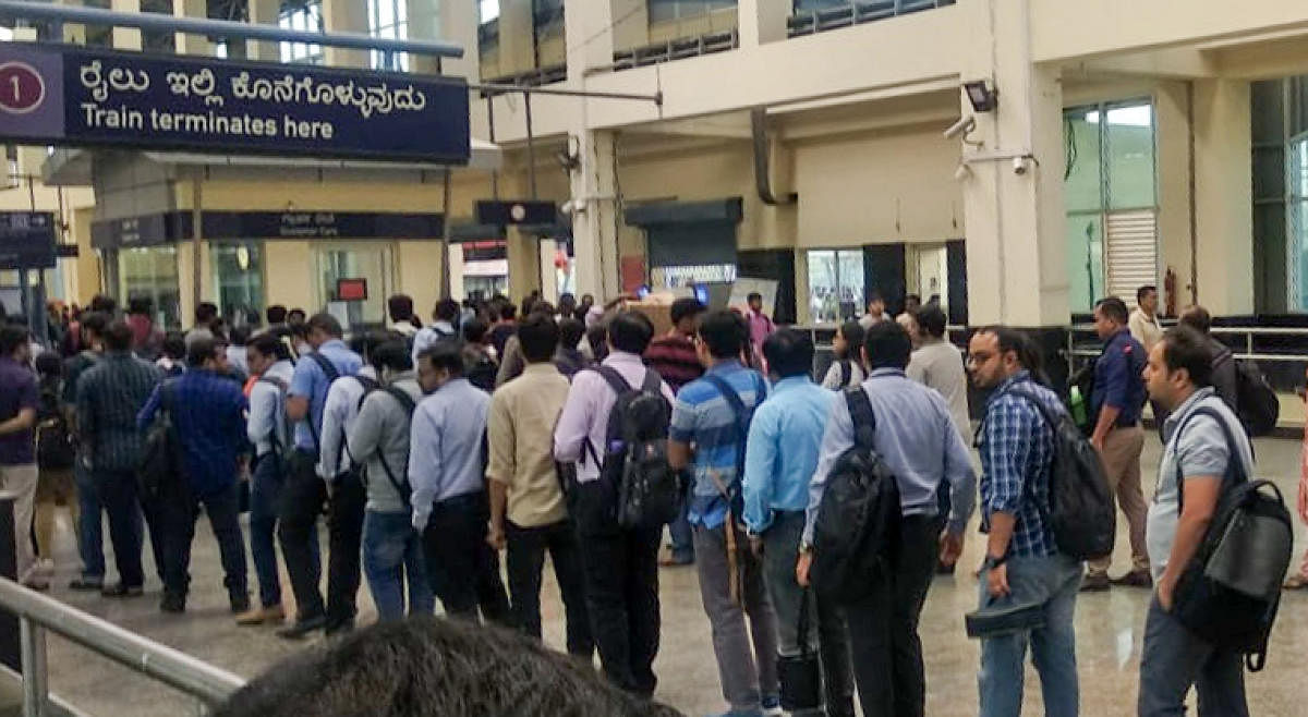 Passengers queue up at the Baiyappanahalli metro station following a glitch on the Purple Line on Monday.