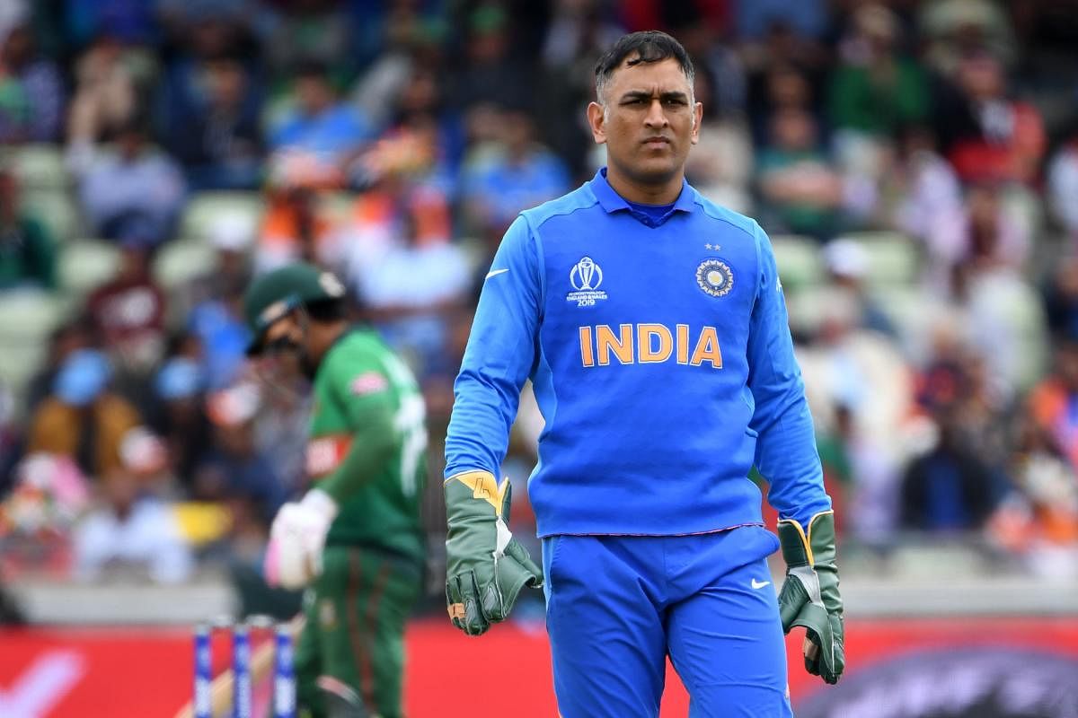 India's Mahendra Singh Dhoni gestures during the 2019 Cricket World Cup group stage match between Bangladesh and India at Edgbaston. Photo credit: AFP