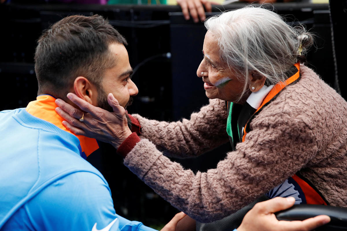GRACIOUS SKIPPER India’s Virat Kohli meets fan Charulata Patel at the end of the match against Bangladesh in Birmingham on Tuesday. Reuters