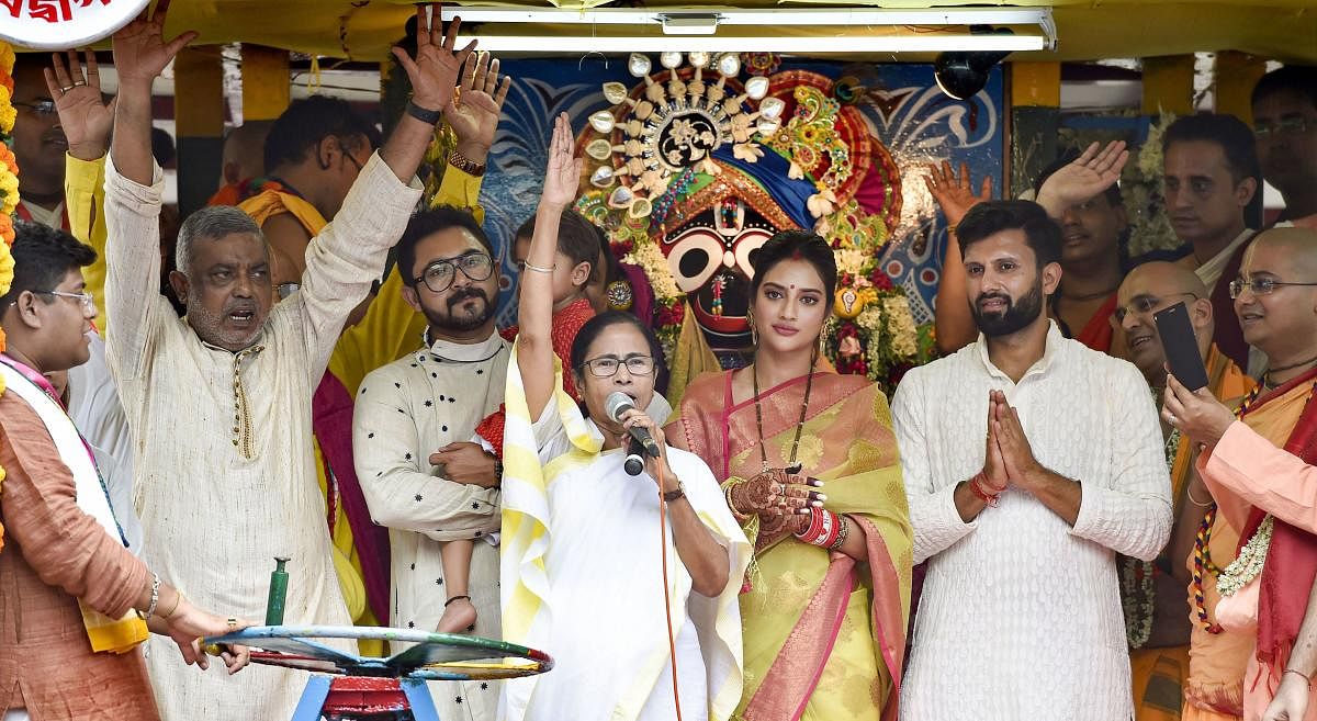 West Bengal Chief Minister Mamata Banerjee with newly elected Trinamool Congress MP and film actress Nusrat Jahan during Rath Yatra event organised by ISKCON, in Kolkata on Thursday. PTI photo
