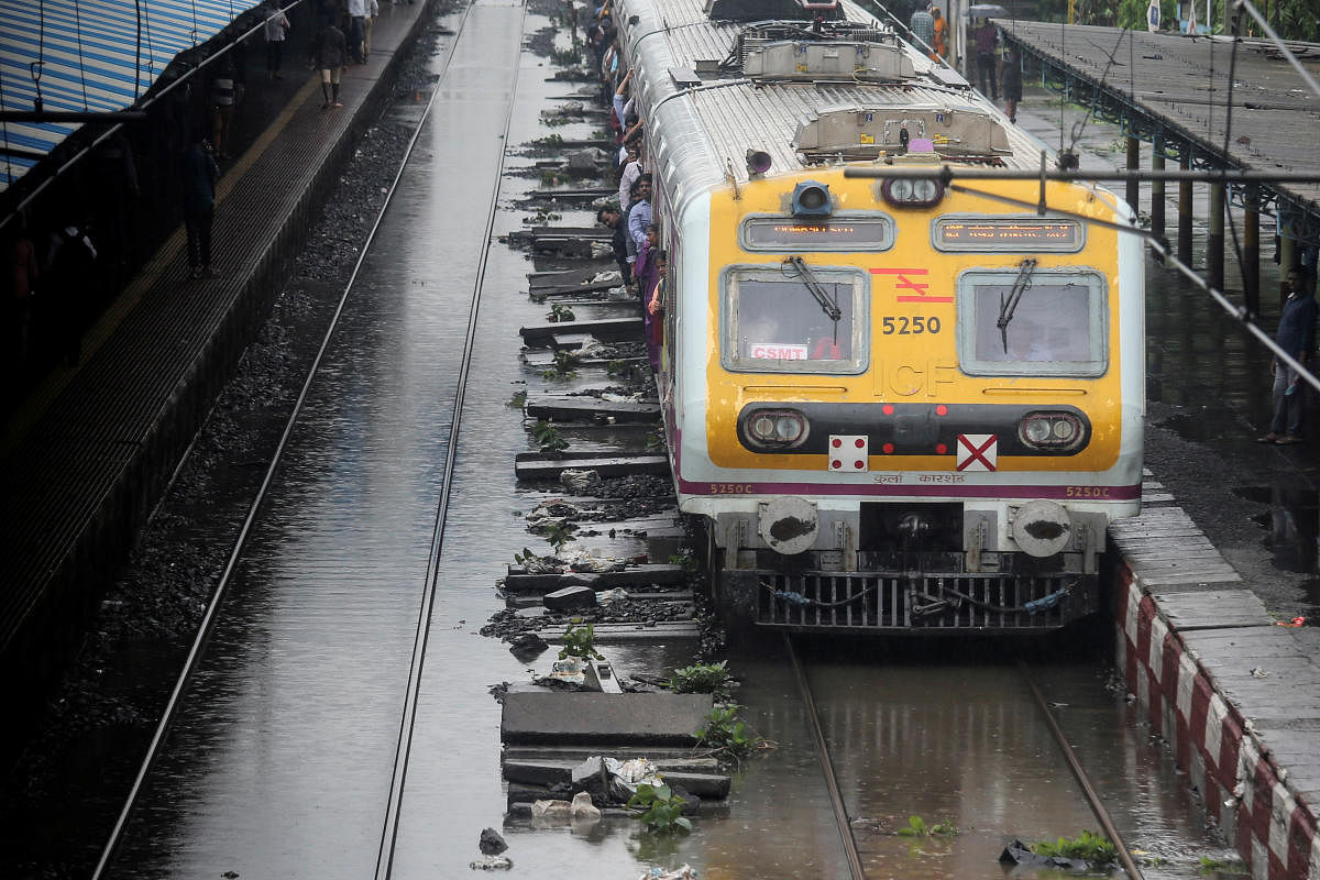 A passenger train moves through a water-logged track during heavy rains in Mumbai. (Photo by REUTERS)