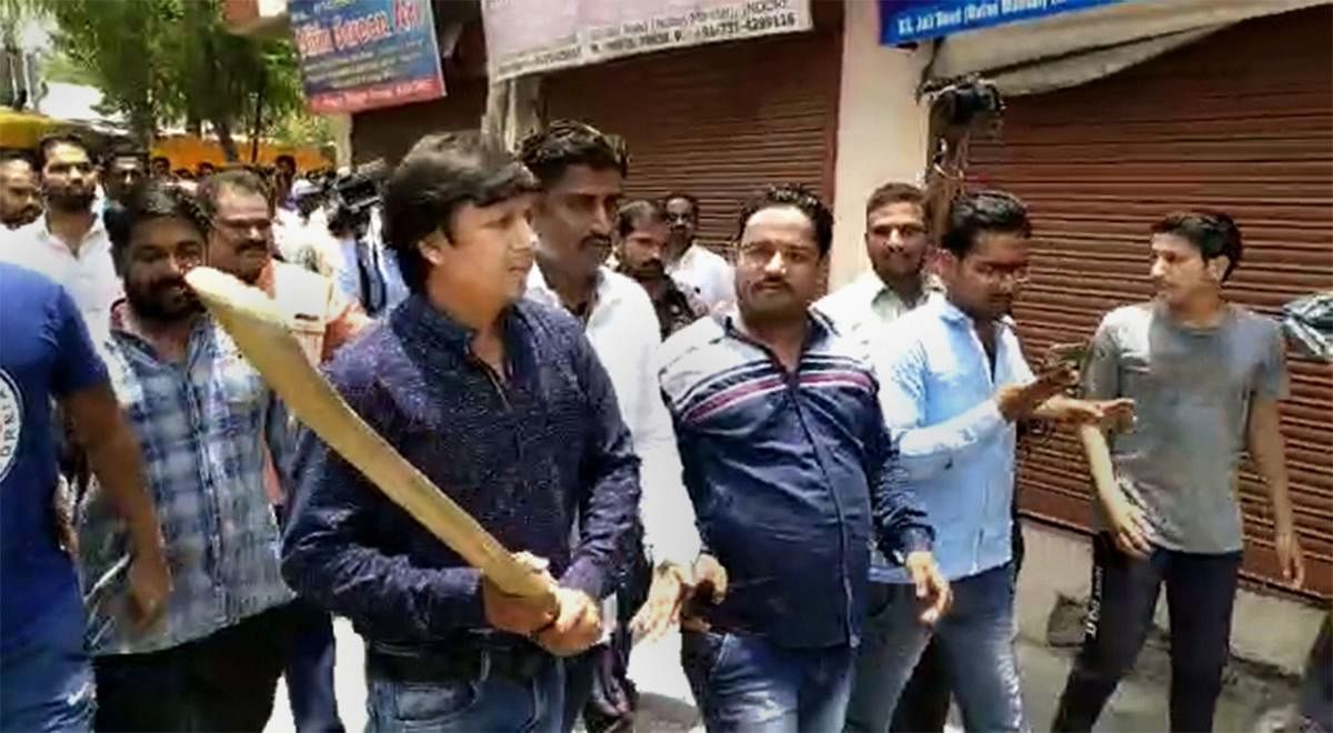 In this video still BJP MLA Akash Vijayvargiya is seen assaulting a civic official with a cricket bat in Indore, Wednesday, June 26, 2019. Vijayvargiya allegedly beat up the official for attempting to demolish a building of his supporter. (PTI Photo)