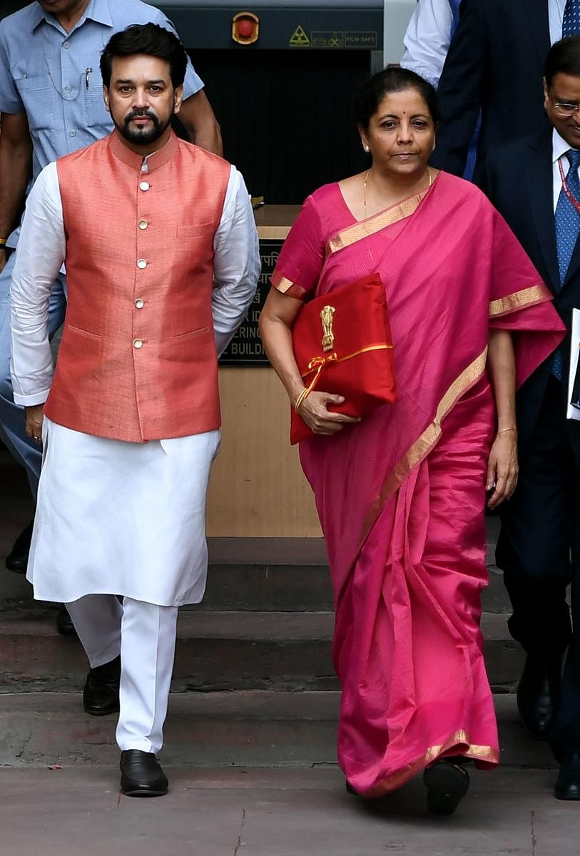 Finance Minister Nirmala Sitharaman (R) with Minister of State for Finance Anurag Thakur (L) leave for Parliament House to table the General Budget 2019-20 in New Delhi on July 5, 2019. AFP