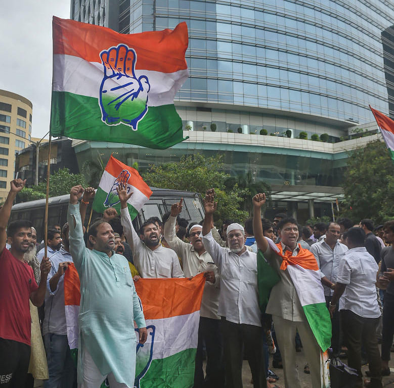  Congress party supporters shout slogans as they protest over the meeting of some Karnataka Congress MLAs with BJP party leaders outside a hotel in Mumbai, Sunday, July 7, 2019. (PTI Photo)