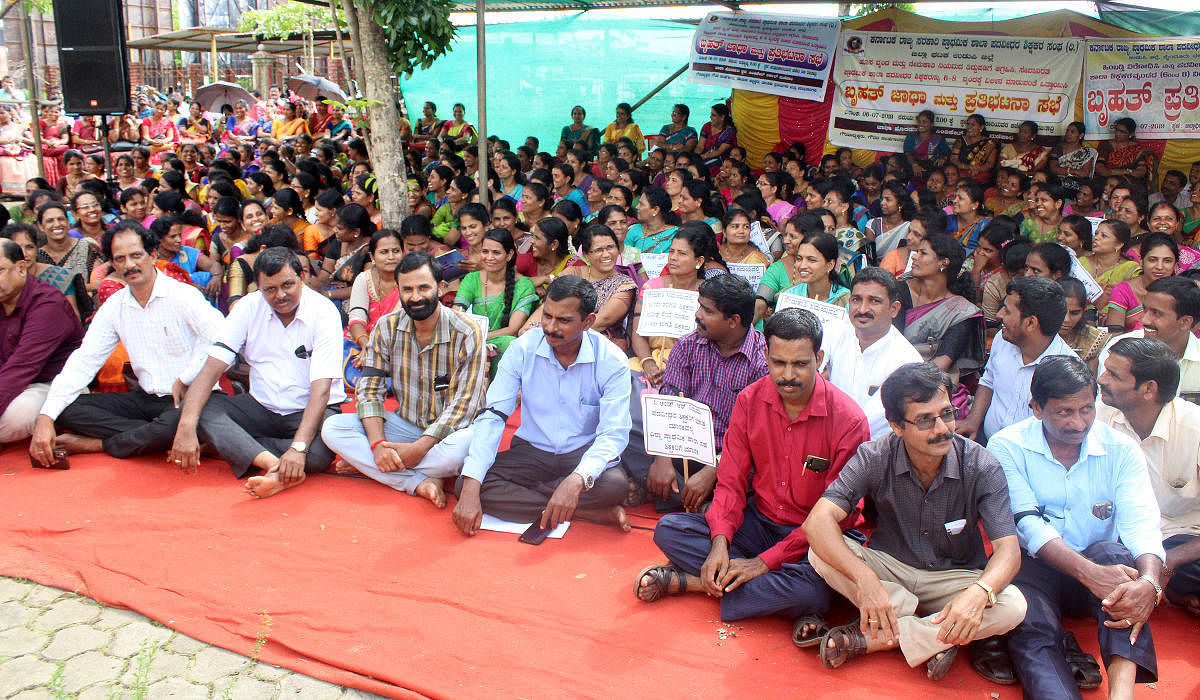 Teachers stage a protest in front of the deputy commissioner’s office in Manipal on Saturday.
