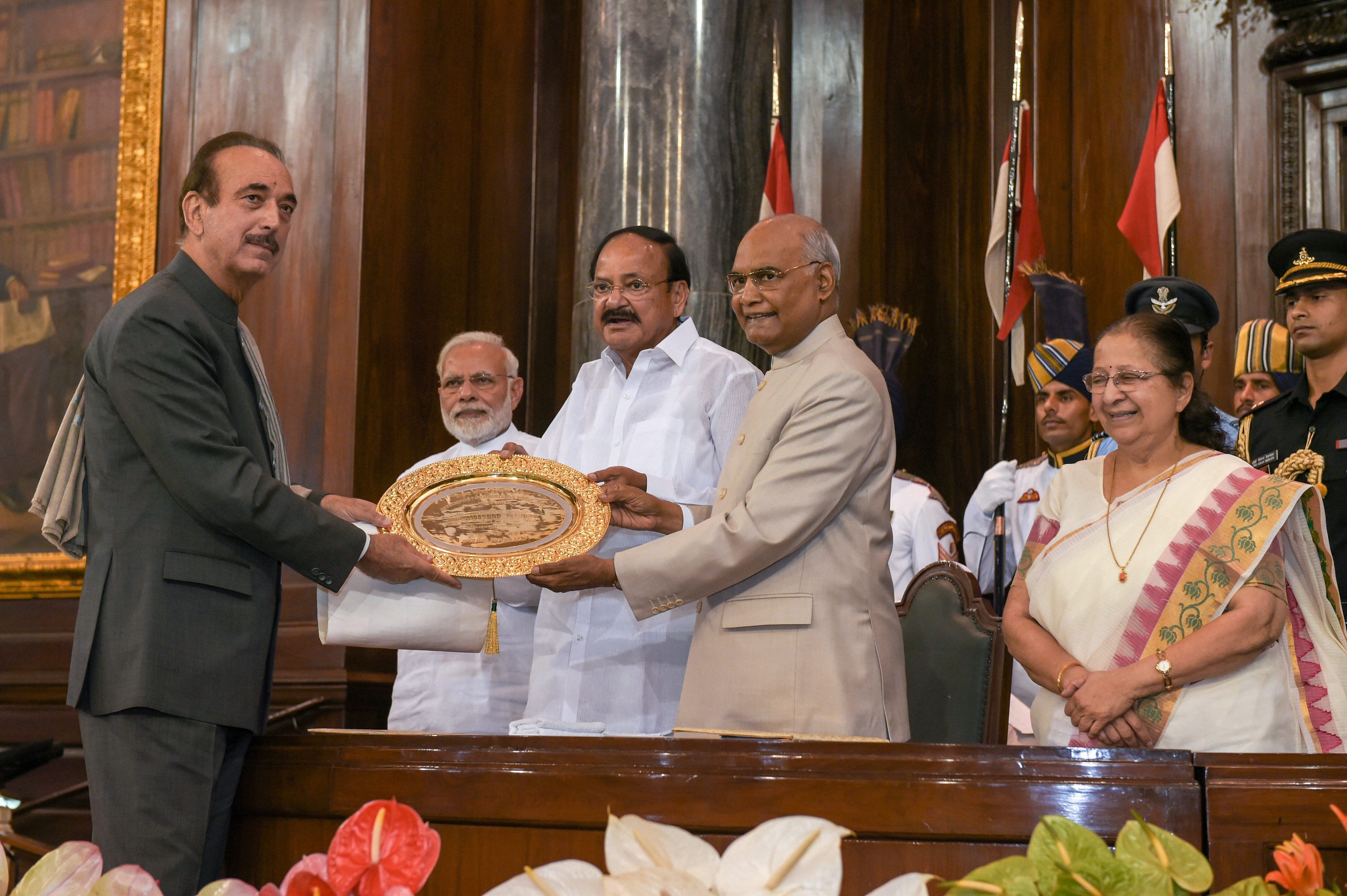 President Ram Nath Kovind confers Outstanding Parliamentarian Award for 2015 to Leader of Opposition in the Rajya Sabha Ghulam Nabi Azad as Vice-President Venkaiah Naidu, Prime Minister Narendra Modi and Lok Sabha Speaker Sumitra Mahajan look on, at the Central Hall of Parliament House, in New Delhi on Wednesday.  PTI