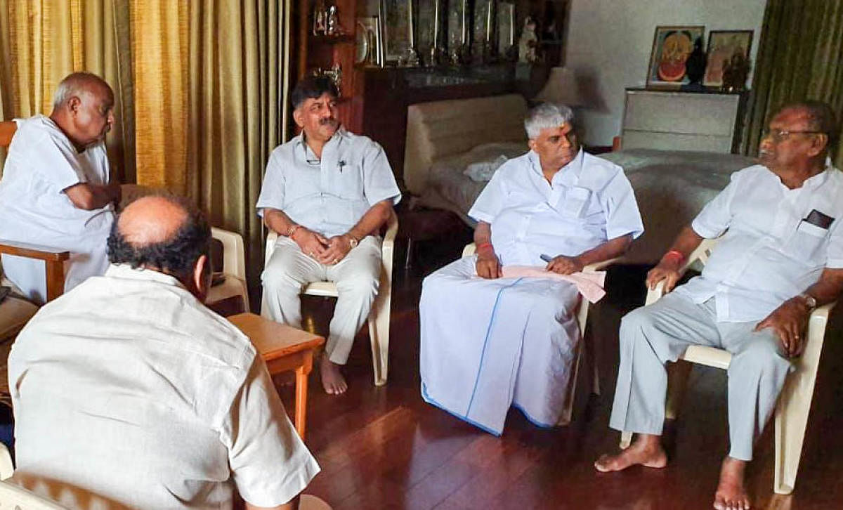 DK Shivakumar with Deve Gowda, PWD Minister HD Revanna and other leaders at Gowda's residence in Bengaluru on Sunday.