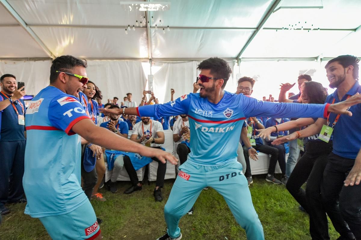 Delhi Capitals captain Shreyas Iyer (right) and team-mate Prithvi Shaw dance with fans before the practice session on the eve of their IPL match against Royal Challengers Bangalore in New Delhi on Saturday. PTI