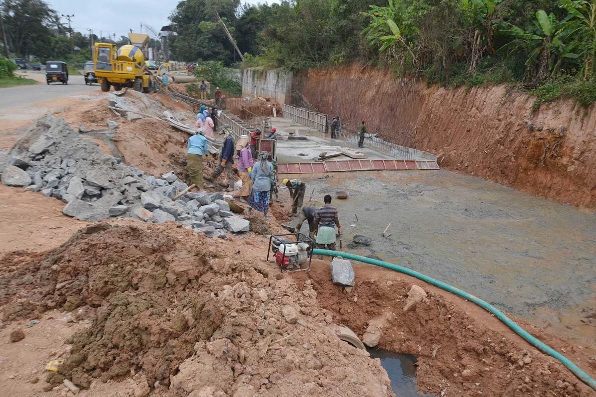 The ongoing work on the protective wall and development of the rajakaluve in Madikeri.