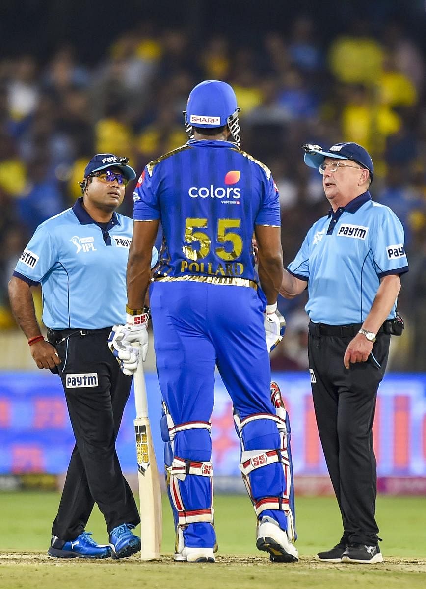 Umpires speak to Mumbai Indians' batsman Kieron Pollard after he expressed his displeasure over a decision in the final against Chennai Super Kings on Sunday. PTI