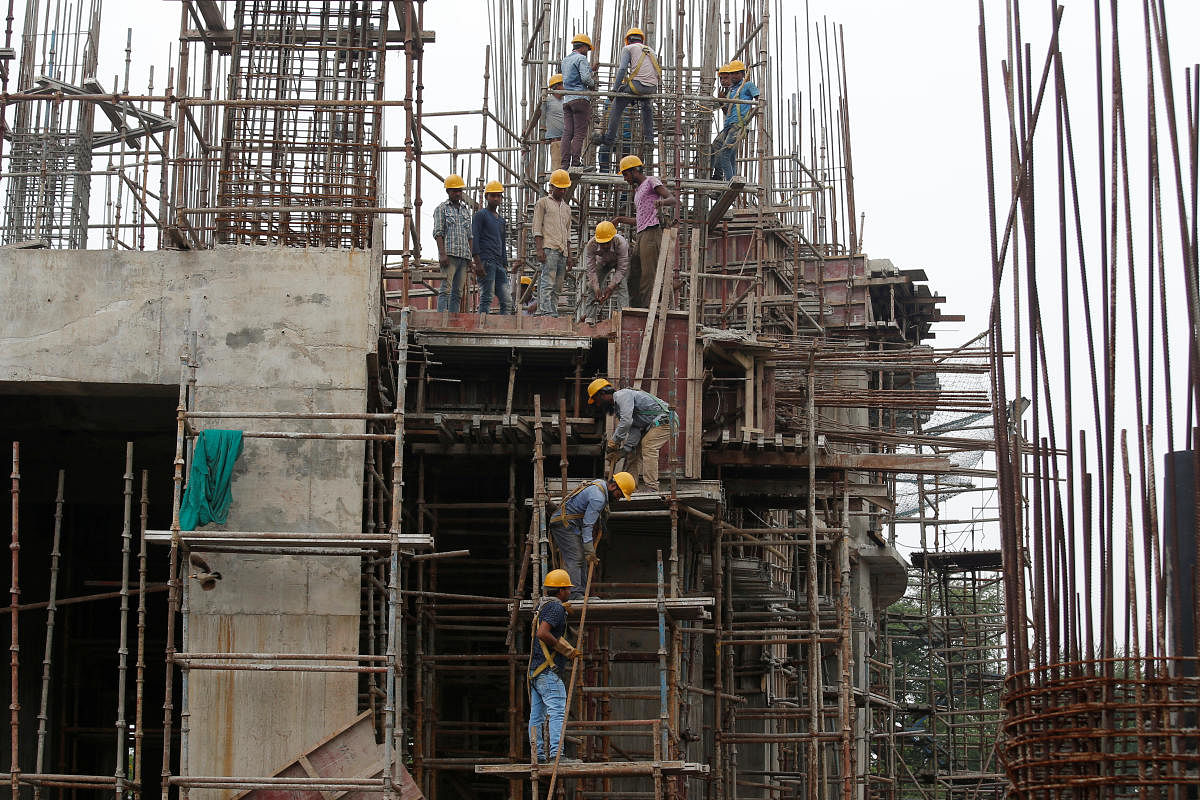 Workers erect scaffolding at a construction site of a metro rail station in Kolkata. REUTERS