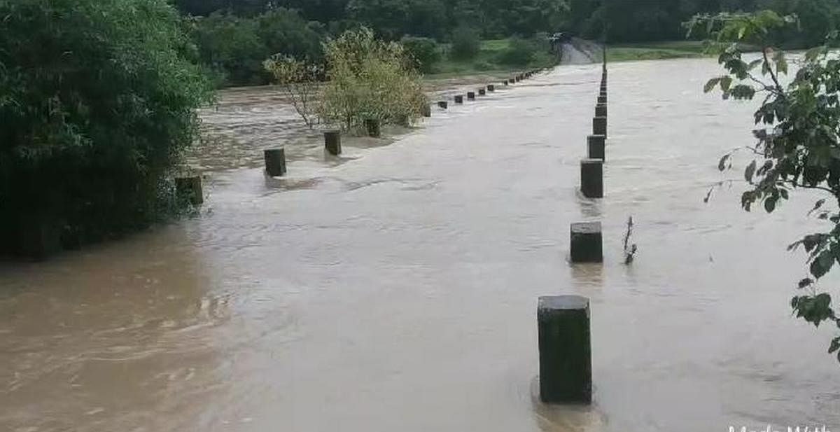 Overflowing Pandri river, a tributary of Kali, leaves Chandbawadi bridge in Joida taluk of Uttara Kannada district submerged.