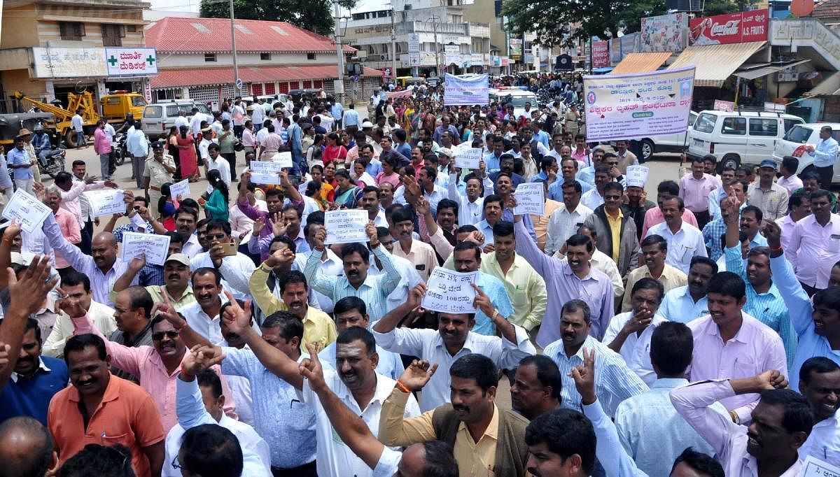 Urging the fulfilment of various demands, primary school teachers take out a protest march in Chikkamagaluru on Tuesday.