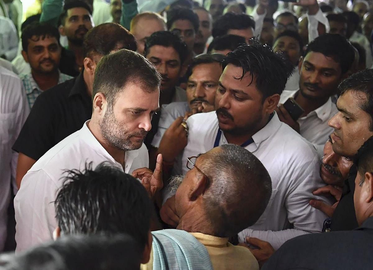 Congress President Rahul Gandhi listens to a party worker during his visit to Amethi on Wednesday. PTI photo