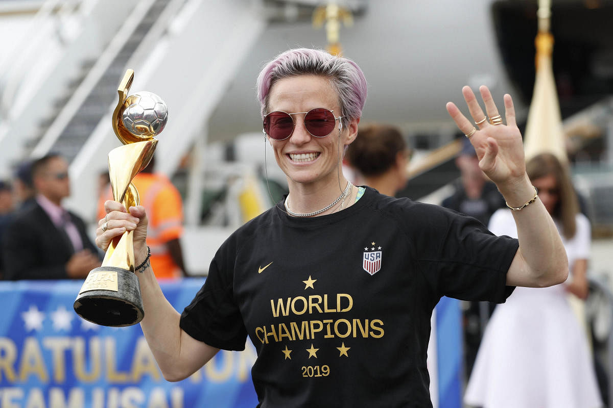 United States women's soccer team member Megan Rapinoe holds the Women's World Cup trophy (PTI Photo)