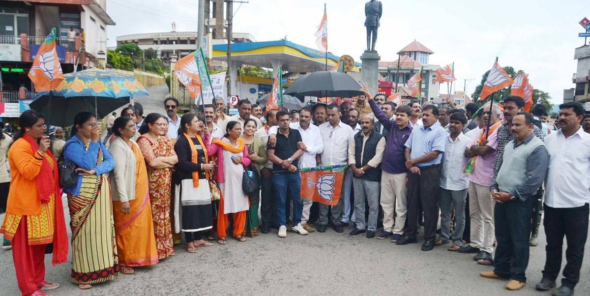 BJP leaders stage a protest at General Thimayya Circle in Madikeri on Tuesday.