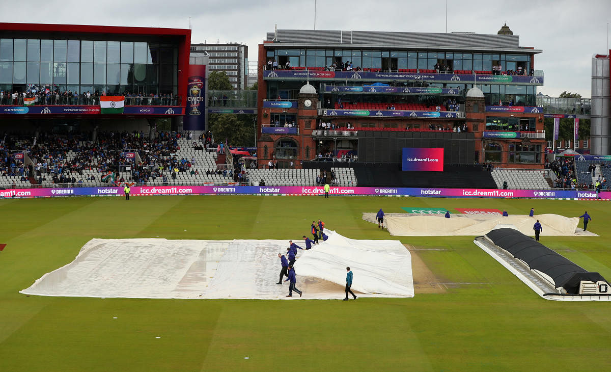 General view of Old Trafford as ground staff remove the covers after a rain delay. (Reuters Photo)