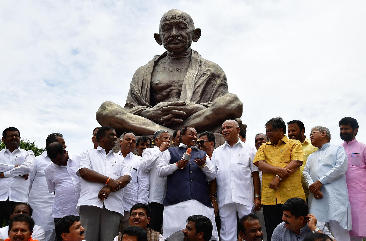 BJP leader K S Eshwarappa addresses party MLAs during a dharna demanding resignation of Chief Minister Kumaraswamy, in front of the Mahatma Gandhi statue on Vidhana Soudha premises, in Bengaluru on Wednesday. DH Photo