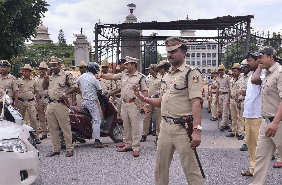  Police personnel stand guard at the entrance of the Vidhana Soudha, in Bengaluru on Thursday. PTI photo