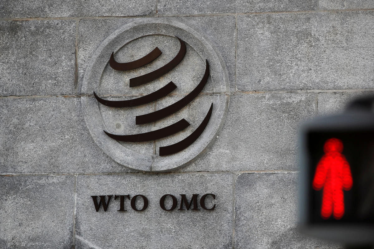 A logo is pictured outside the World Trade Organization (WTO) headquarters next to a red traffic light in Geneva, Switzerland. REUTERS