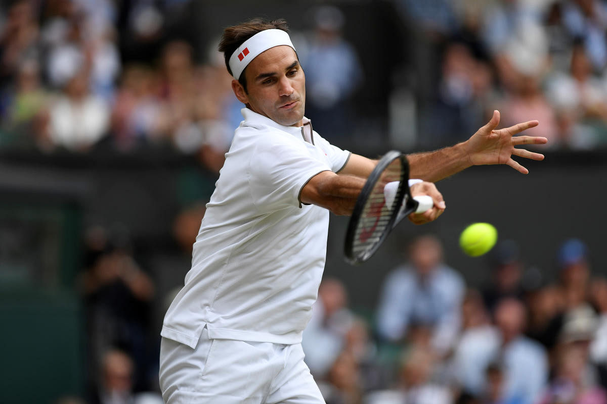 ON FIRE: Switzerland's Roger Federer returns during his win over Japan's Kei Nishikori during the men's singles quarterfinal on Wednesday. 