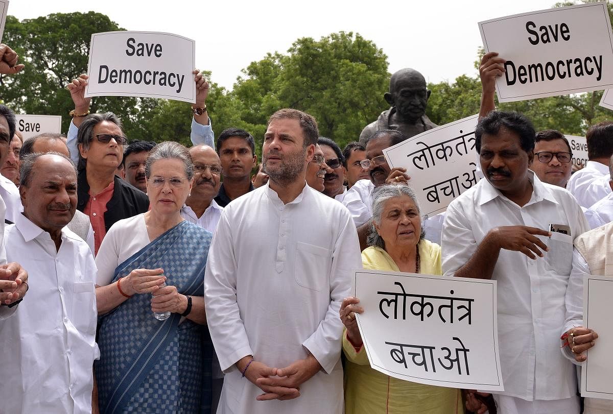 Congress MPs, led by CPP leader Sonia Gandhi, party leader Rahul Gandhi, stage a protest outside at Parliament House on Thursday, against the 'attempts' by the BJP to unsettle coalition government in Karnataka. AFP