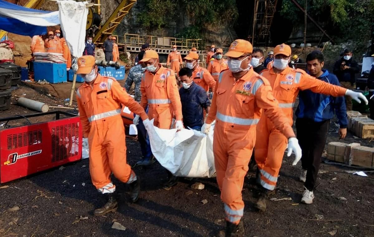 National Disaster Response Force (NDRF) and Indian Naval personnel carry an unidentified body of a trapped miner during a joint operation in Ksan area of East Jaintia Hills, Thursday, Jan. 24, 2019. (PTI Photo)