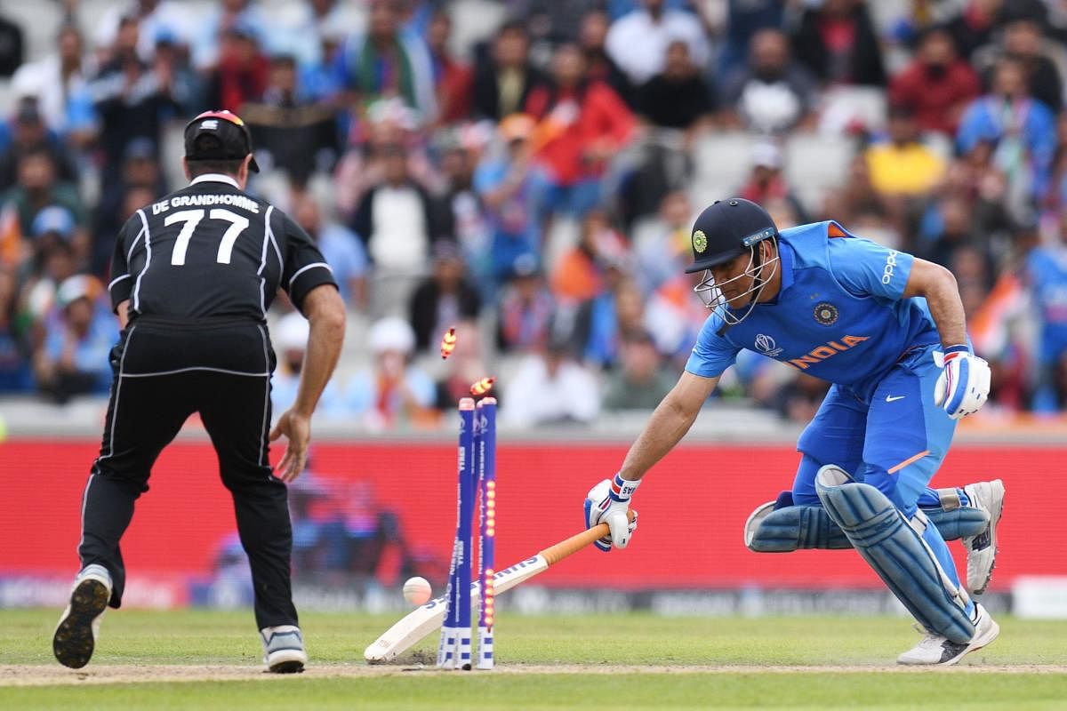 India's Mahendra Singh Dhoni was run out during the 2019 Cricket World Cup first semi-final between New Zealand and India at Old Trafford in Manchester, northwest England, on July 10, 2019. (Photo by AFP)