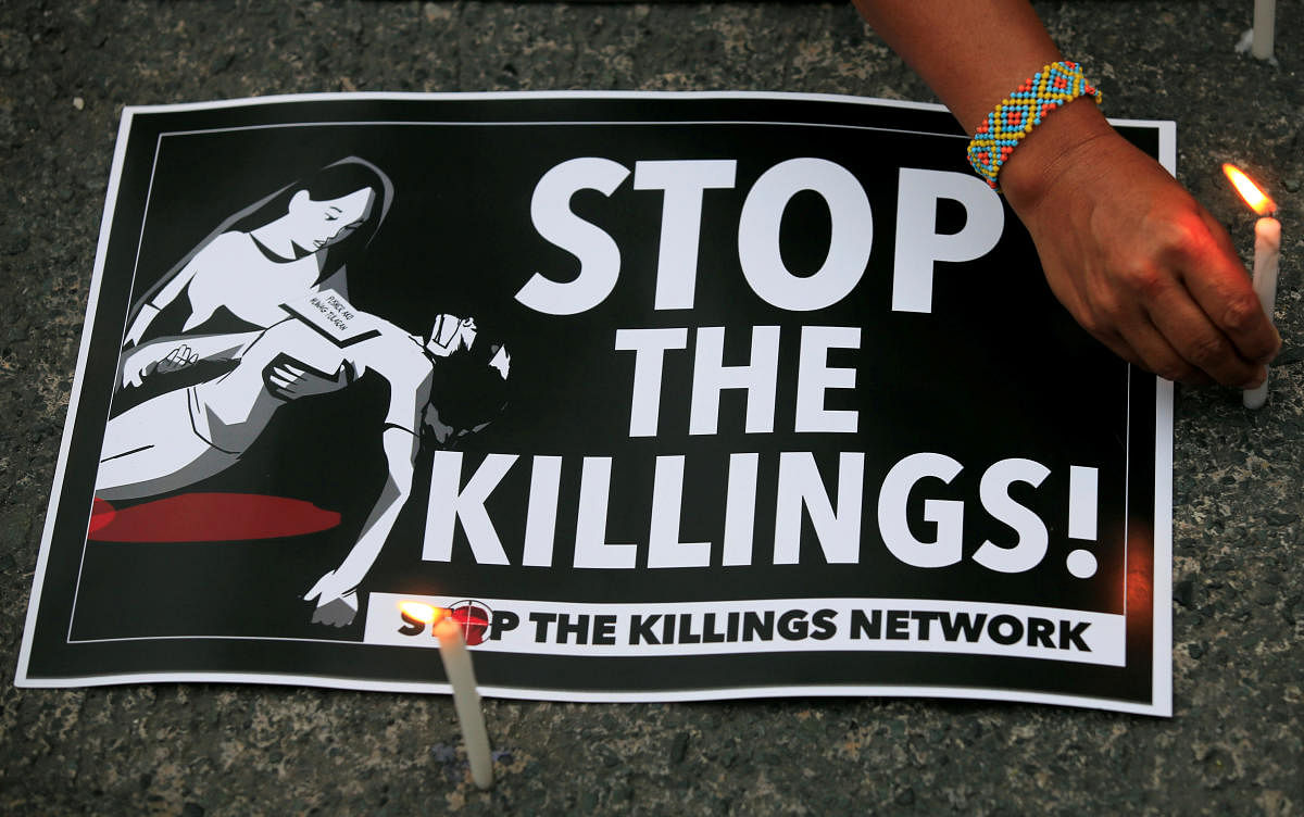 A protester lights candles next to a placard, seeking justice for 17-year-old high school student Kian delos Santos, who was killed in a recent police raid in an escalation of President Rodrigo Duterte's war on drugs. (Reuters Photo)