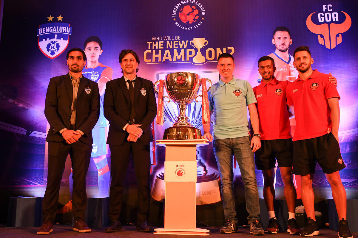  (From left) Bengaluru FC's Dimas Delgado, head coach Carles Cuadrat, FC Goa's coach Sergio Lobera, Mandar Dessai and Ferran Corominas pose with ISL trophy on the eve of the final in Mumbai. ISL MEDIA 