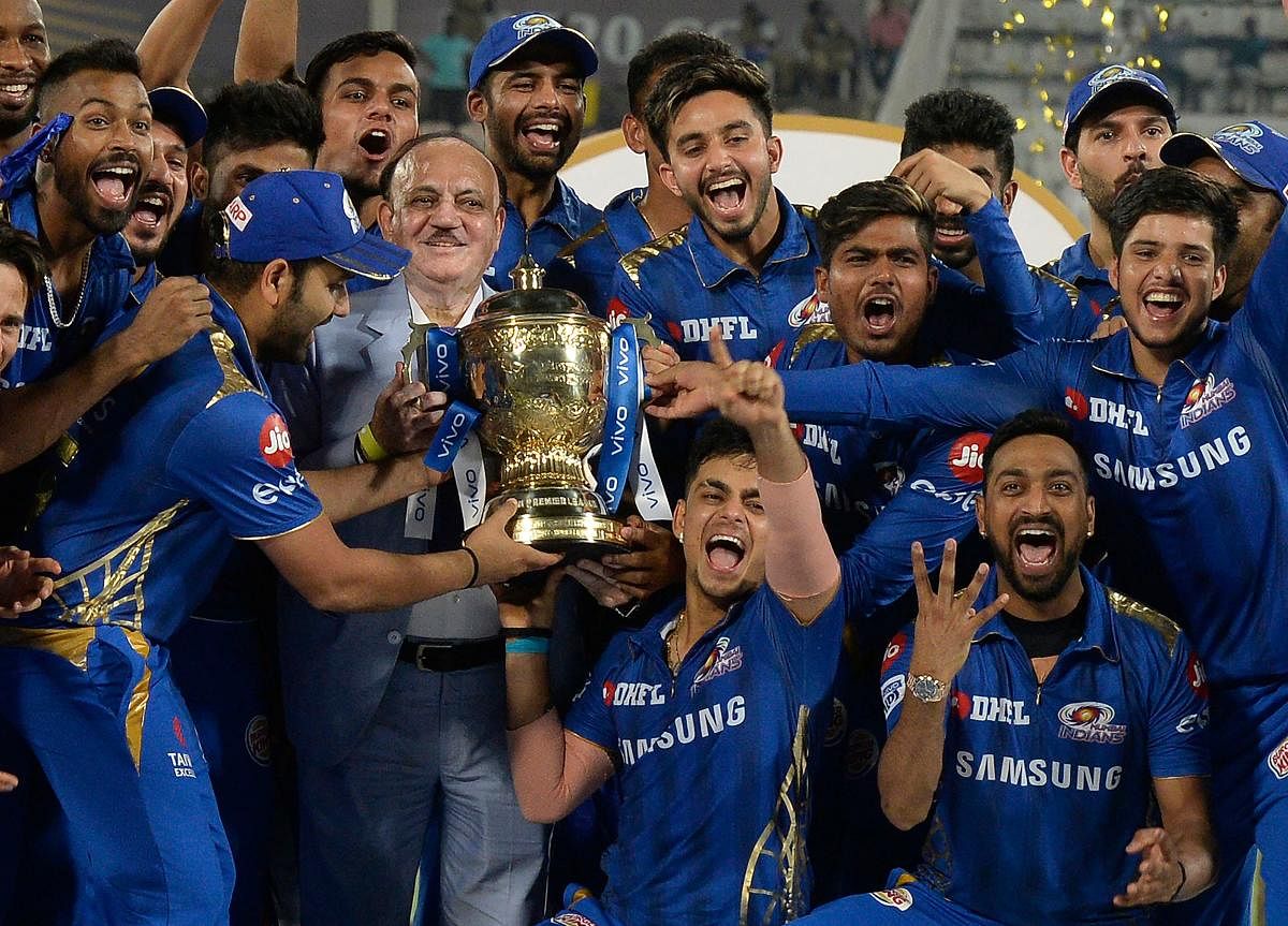 Mumbai Indians' players celebrate with the IPL trophy. AFP