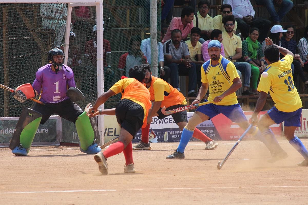 Aiming for a Goal: A match in progress during the Kodava Hockey Festival 2016 in Madikeri, Kodagu. Photos by DH, Niran Shantheyanda