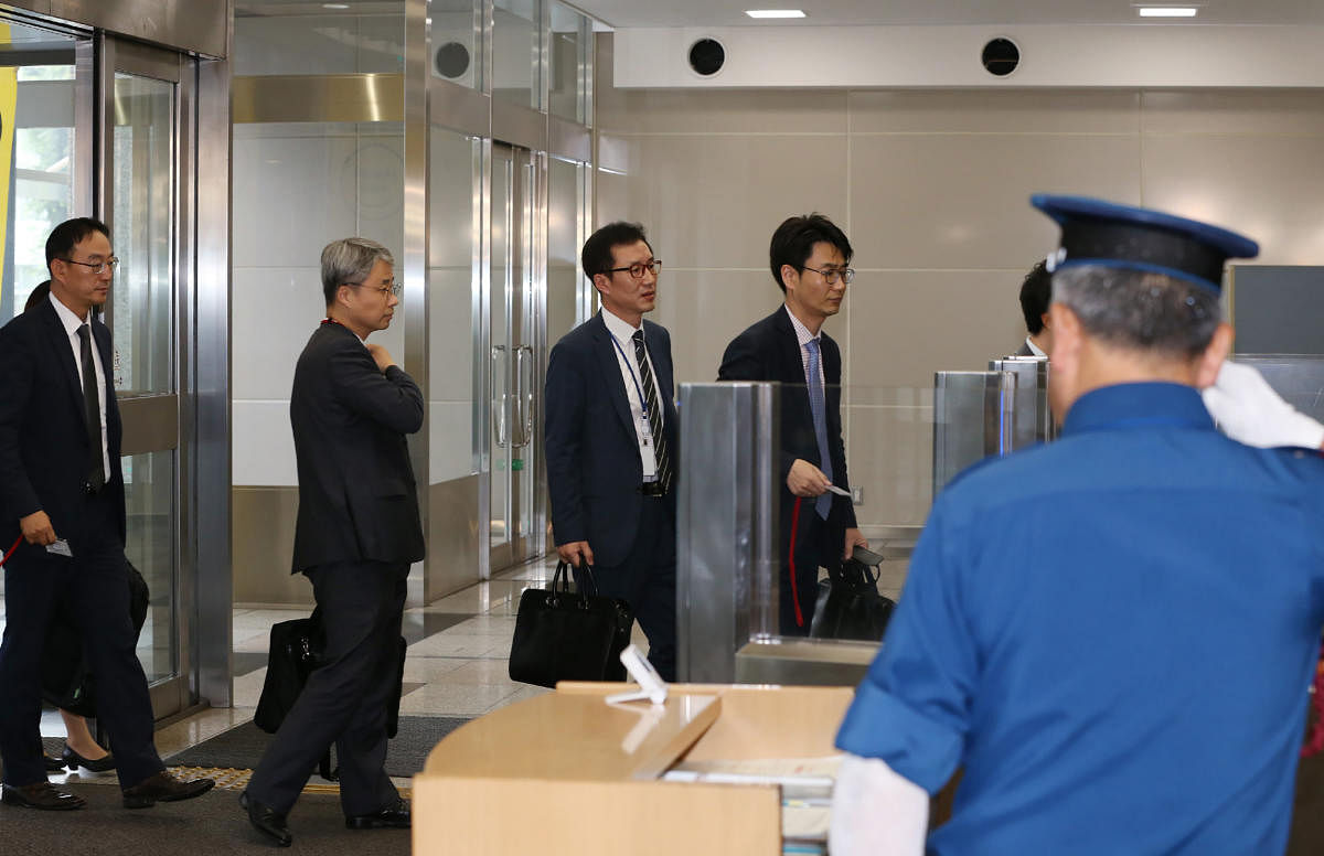 South Korea's officers enters the Ministry of Economy, Trade and Industry to hold a talk with their Japanese counterpart on the imposed restrictions, ending expedited shipments of chemical compounds used to manufacture microchips and smartphones in Tokyo