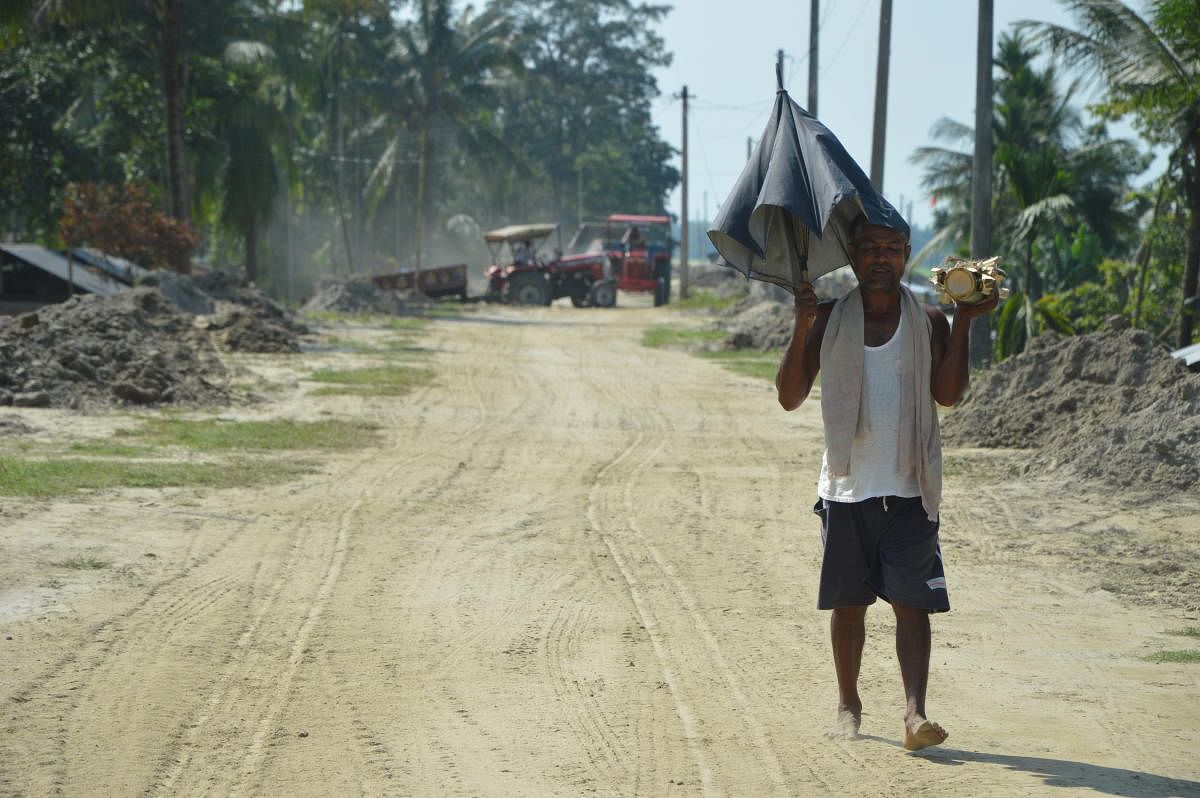A man walks on the embankment encircling the Majuli island to protect it from annual floods.